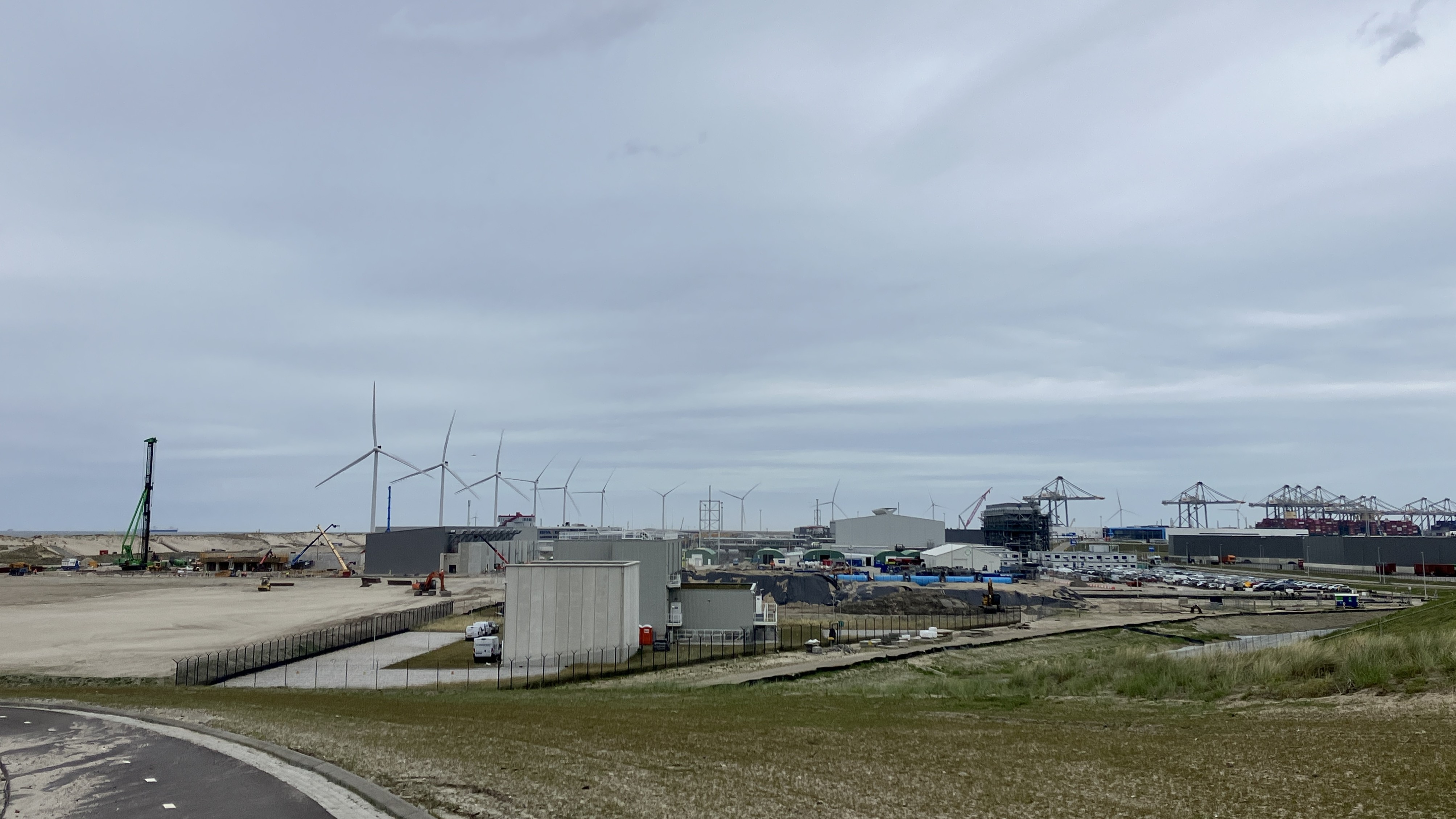 Waterstofconversiepark op de Tweede Maasvlakte, met op de achtergrond de ELYgator en Holland Hydrogen I in aanbouw. Op de voorgrond ruimte voor nog twee eletrolysers.  Foto: Tijdo van der Zee